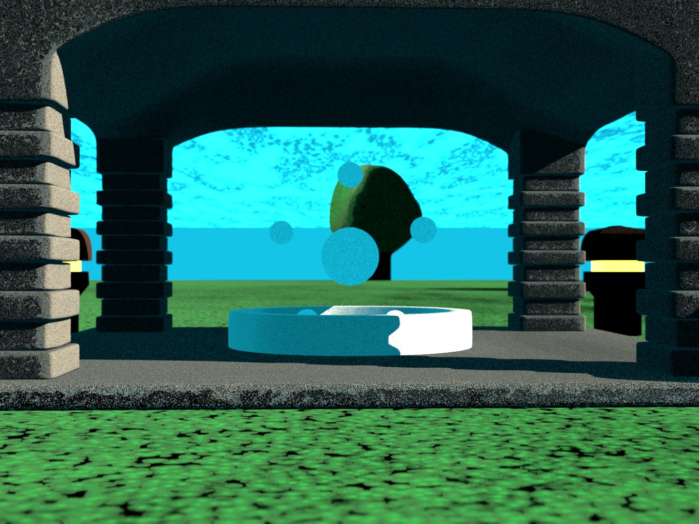 some orbs floating in a fountian on a grassy grounds with a stone stucture over it.